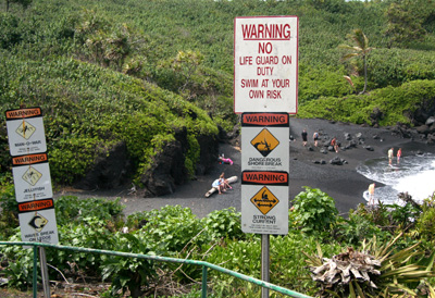 [ Warning signs at black sand beach ]