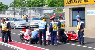 [

Race officials inspect a Toyota ]