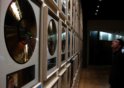 [ James checks out gold and platinum records ]